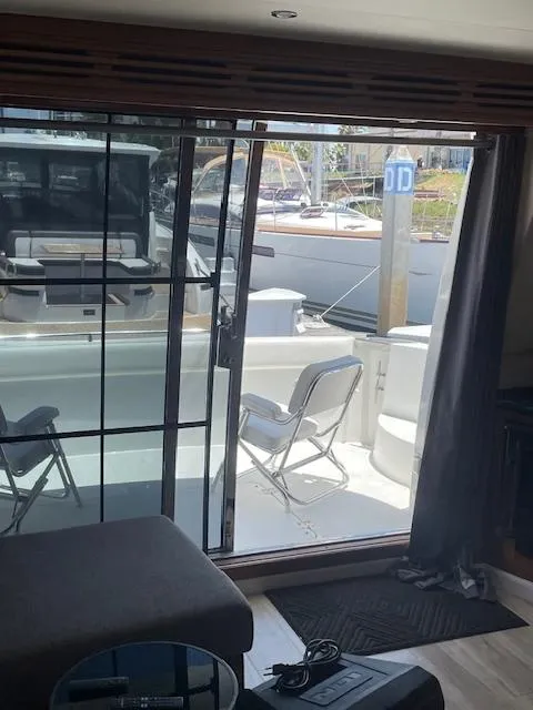 Slide: The Image of Interior view of 2000 Carver 530 Voyager Pilothouse with open sliding door to deck. - 11