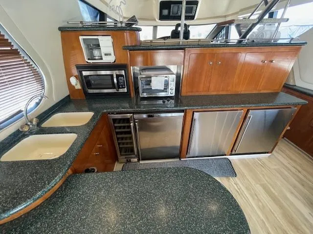 Slide: The Image of Luxurious kitchen in 2000 Carver 530 Voyager Pilothouse with modern appliances and sleek countertops. - 13