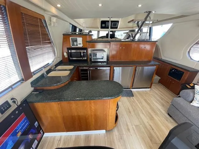 Slide: The Image of Luxurious kitchen interior of 2000 Carver 530 Voyager Pilothouse yacht with modern appliances. - 14
