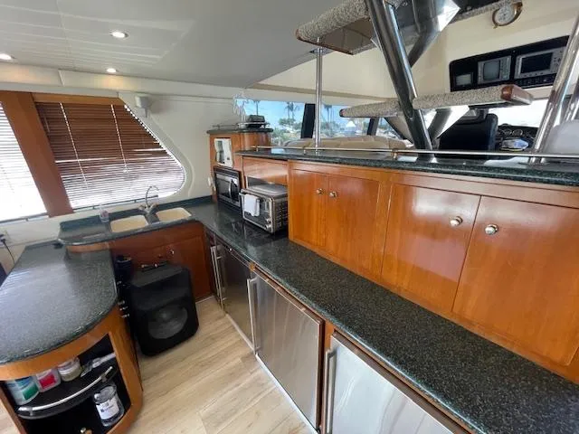 Slide: The Image of Interior of 2000 Carver 530 Voyager Pilothouse with modern kitchen amenities. - 16