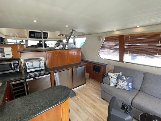 Slide: The Image of Luxurious interior of 2000 Carver 530 Voyager Pilothouse with modern kitchen and cozy seating area. - 17