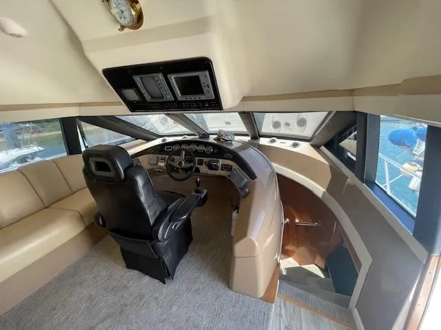 Slide: The Image of Pilothouse interior of 2000 Carver 530 Voyager, featuring helm and seating area. - 21