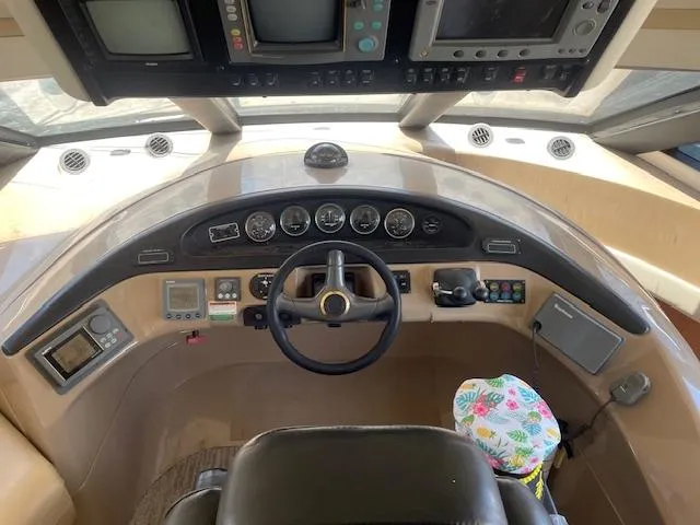Slide: The Image of Pilothouse interior of 2000 Carver 530 Voyager, featuring steering wheel and control panels. - 27