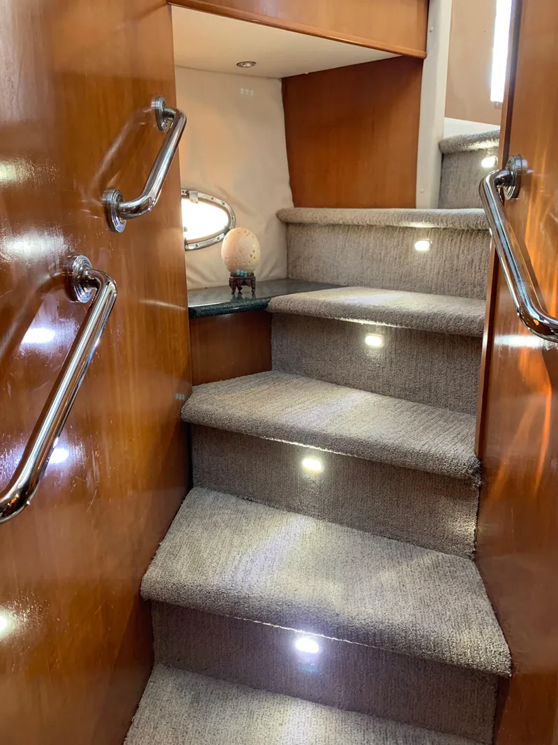 Slide: The Image of Staircase inside 2000 Carver 530 Voyager Pilothouse with carpet and wooden handrails. - 29