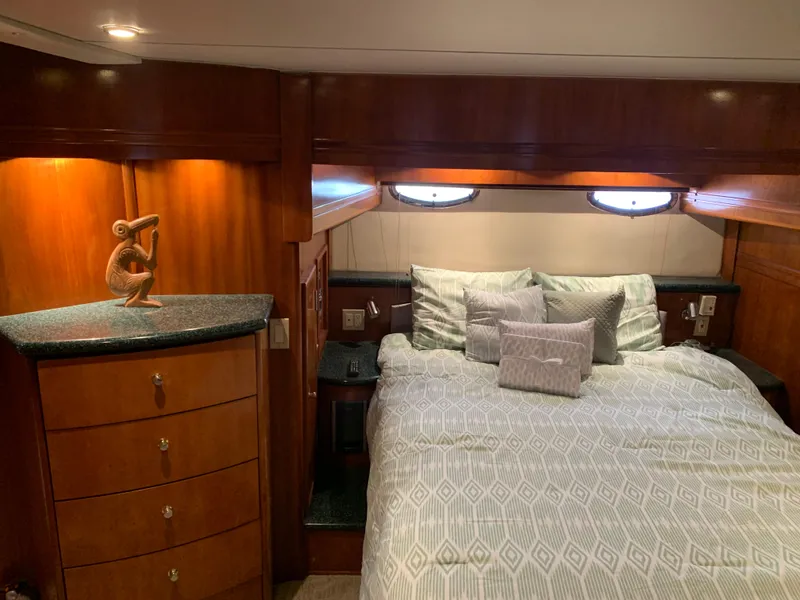 Slide: The Image of Luxurious bedroom in 2000 Carver 530 Voyager Pilothouse yacht with elegant wood cabinetry. - 34