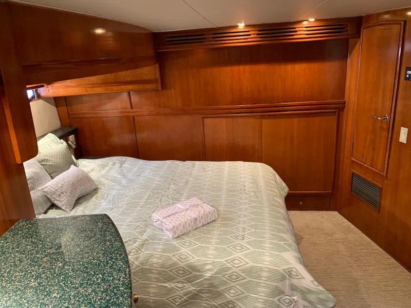 Slide: The Image of Luxurious bedroom interior of 2000 Carver 530 Voyager Pilothouse yacht with wood paneling. - 35
