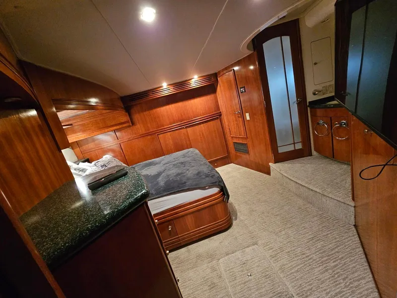 Slide: The Image of Luxurious interior of 2000 Carver 530 Voyager Pilothouse with wood paneling and cozy bed. - 36