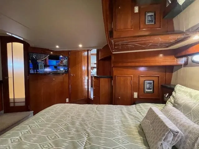 Slide: The Image of Luxurious interior of 2000 Carver 530 Voyager Pilothouse with wood cabinetry and cozy bedding. - 37
