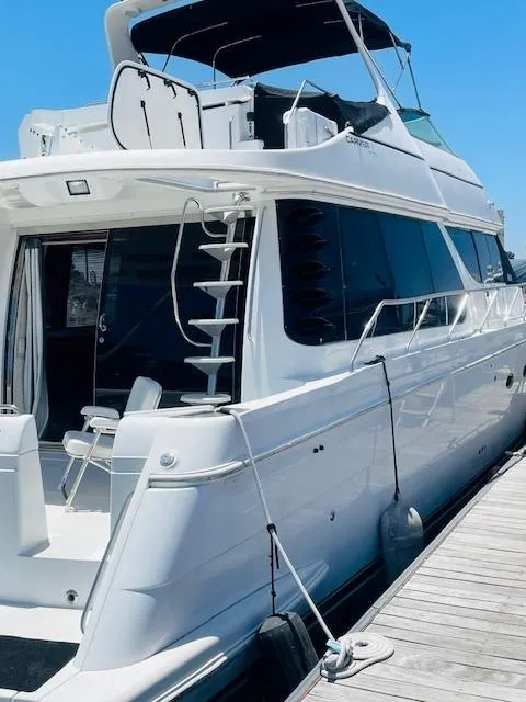 Slide: The Image of 2000 Carver 530 Voyager Pilothouse yacht docked at marina, side view. - 4