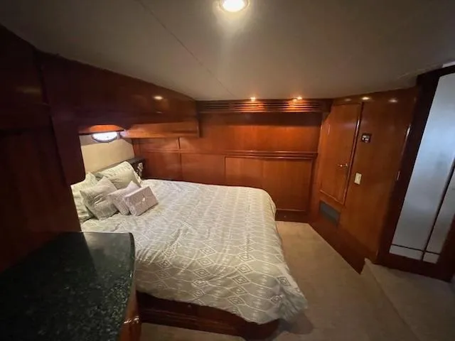 Slide: The Image of Luxurious bedroom interior of 2000 Carver 530 Voyager Pilothouse yacht with wood paneling. - 41