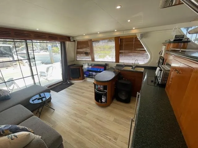 Slide: The Image of Interior of 2000 Carver 530 Voyager Pilothouse with modern kitchen and seating area. - 7