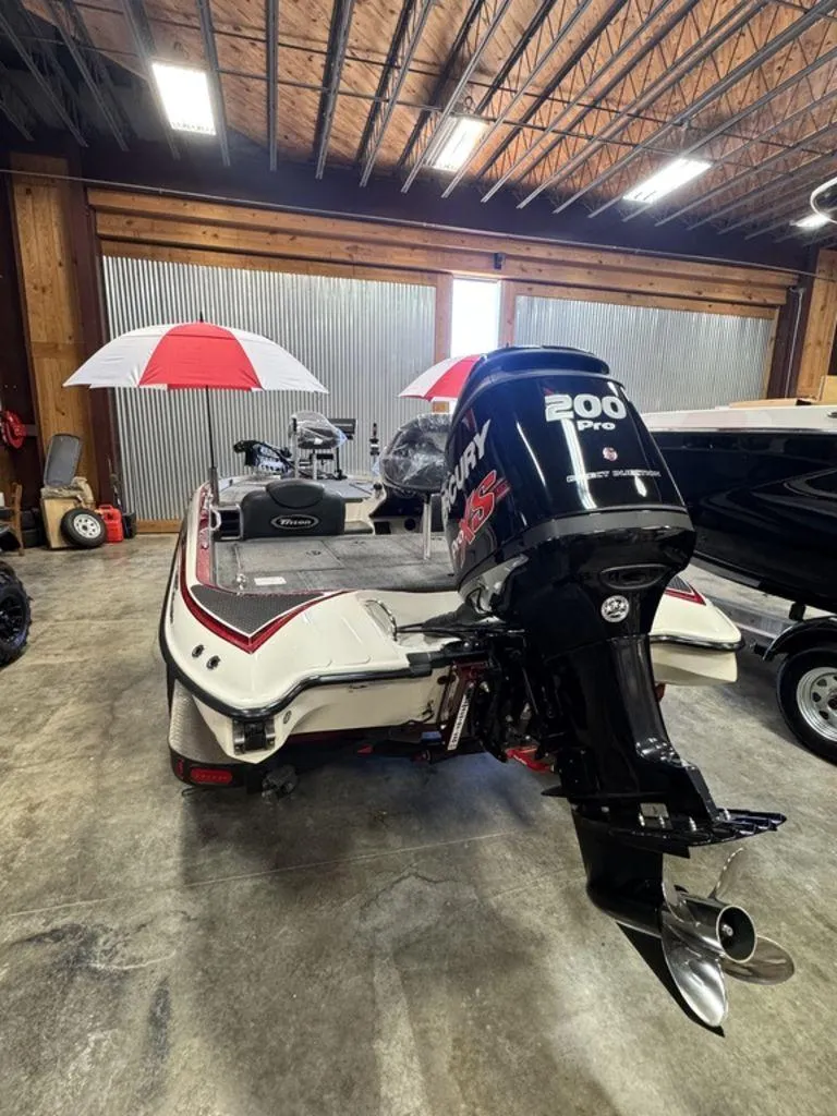 Slide: The Image of 2016 Triton 18 TrX boat with Mercury 200 Pro XS engine in a garage. - 11
