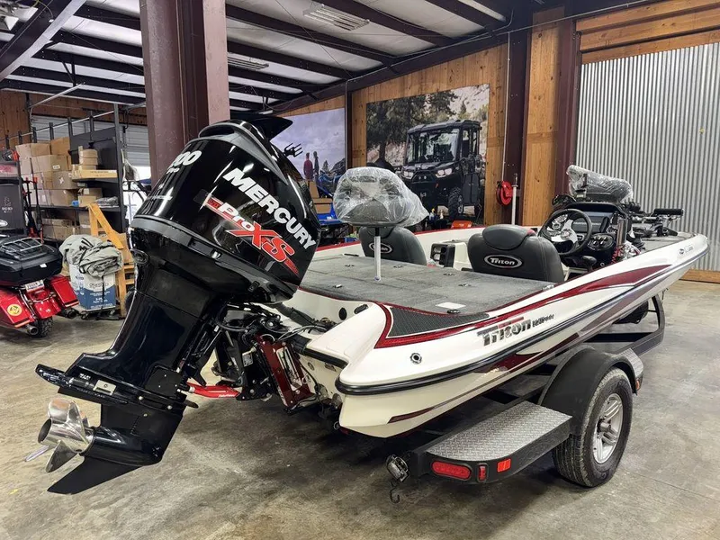 Slide: The Image of 2016 Triton 18 TrX boat with Mercury Pro XS engine in a garage setting. - 2