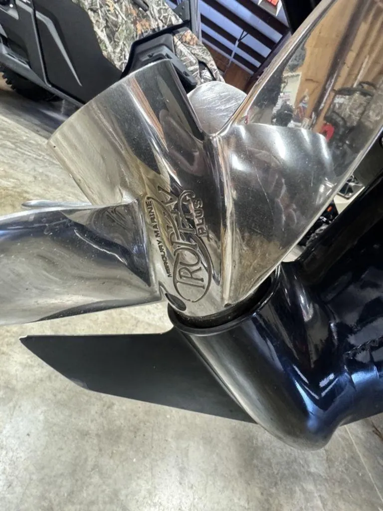 Slide: The Image of Close-up of a 2016 Triton 18 TrX boat propeller in a garage setting. - 22