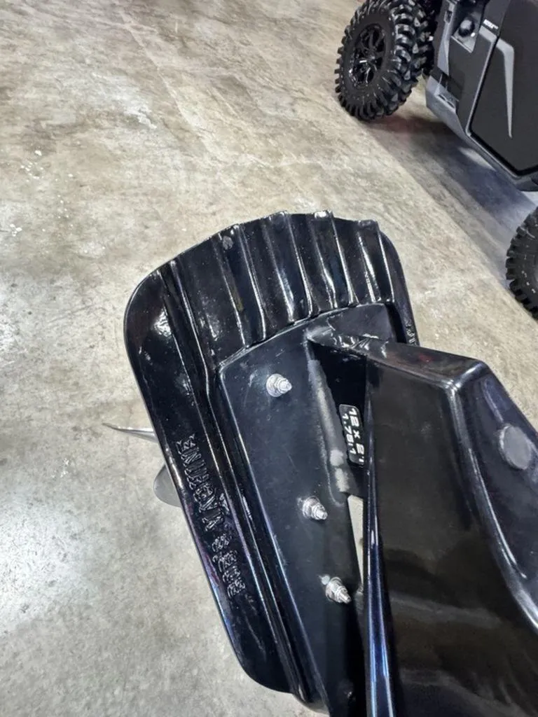 Slide: The Image of Close-up of a 2016 Triton 18 TrX boat part on a concrete floor. - 23