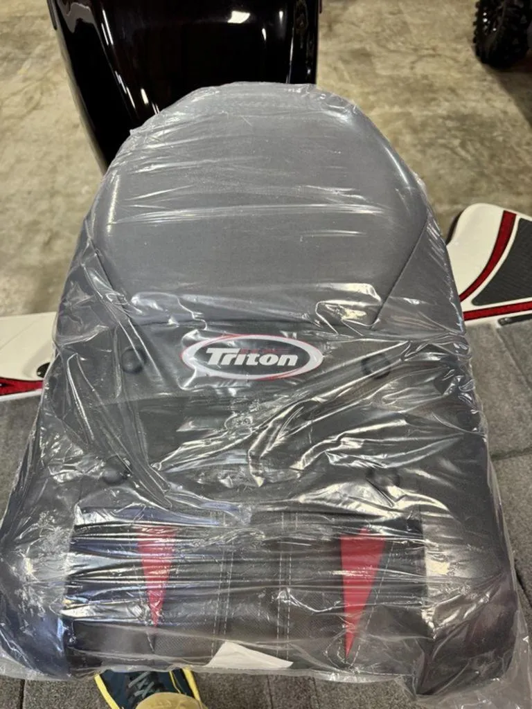 Slide: The Image of 2016 Triton 18 TrX boat seat covered in protective plastic wrap. - 26