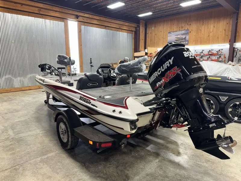 Slide: The Image of 2016 Triton 18 TrX boat with Mercury Pro XS engine in a showroom. - 3