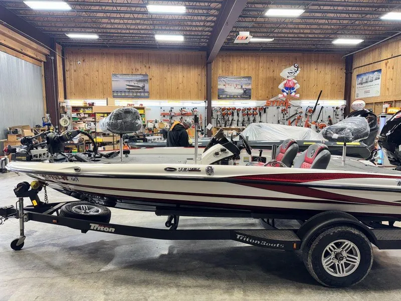 Slide: The Image of 2016 Triton 18 TrX boat in a showroom, featuring red and white design. - 4