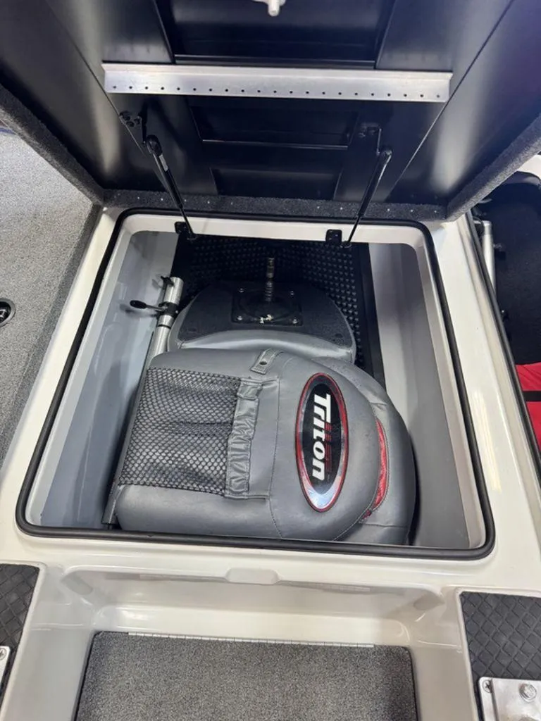 Slide: The Image of 2016 Triton 18 TrX boat storage compartment with seat and equipment. - 40