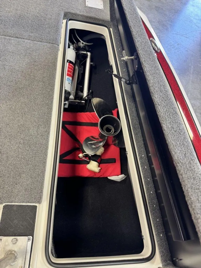 Slide: The Image of Storage compartment of a 2016 Triton 18 TrX boat with propeller and equipment. - 41