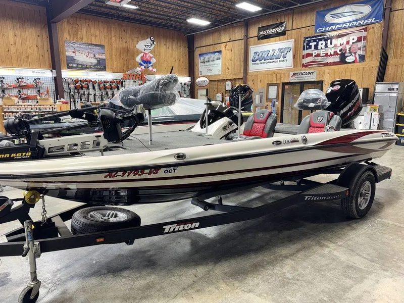 Slide: The Image of 2016 Triton 18 TrX boat on trailer in showroom with fishing gear. - 5