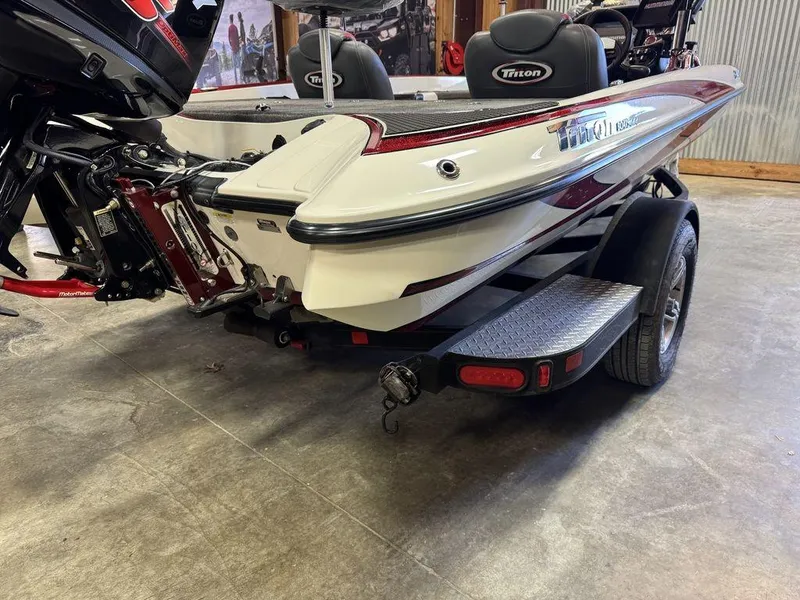 Slide: The Image of 2016 Triton 18 TrX boat on trailer, rear view in garage setting. - 6