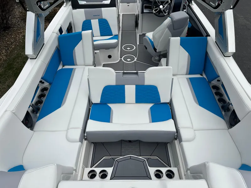Slide: The Image of 2023 MasterCraft X24 boat interior with blue and white seating, modern design. - 11