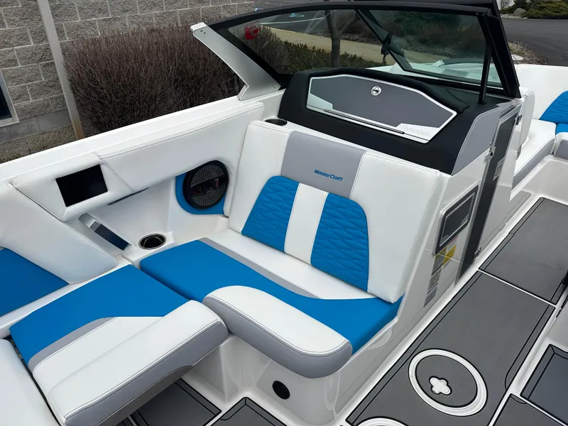 Slide: The Image of 2023 MasterCraft X24 boat interior with blue and white seating, modern design. - 15