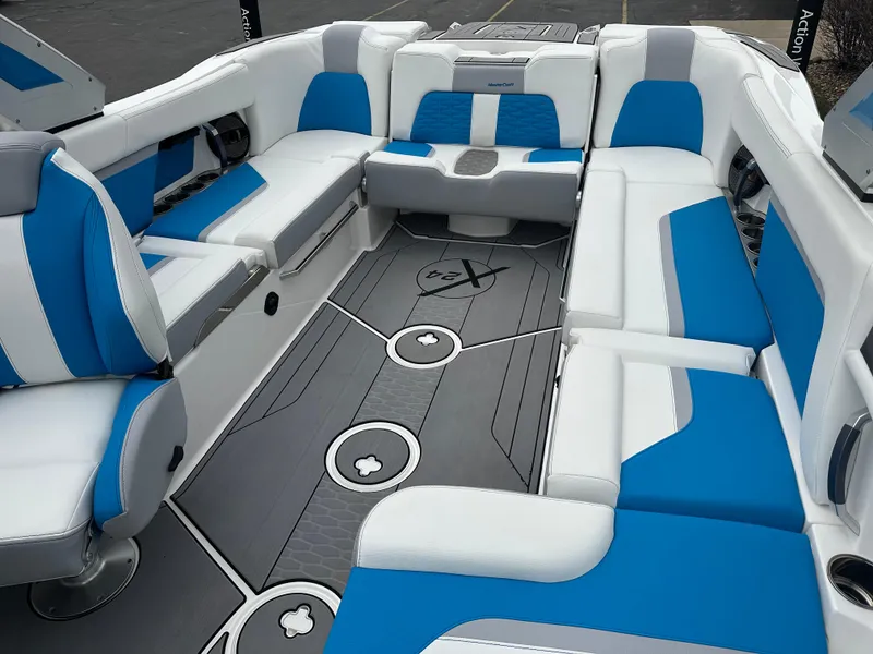 Slide: The Image of 2023 MasterCraft X24 boat interior with blue and white seating, modern design. - 17
