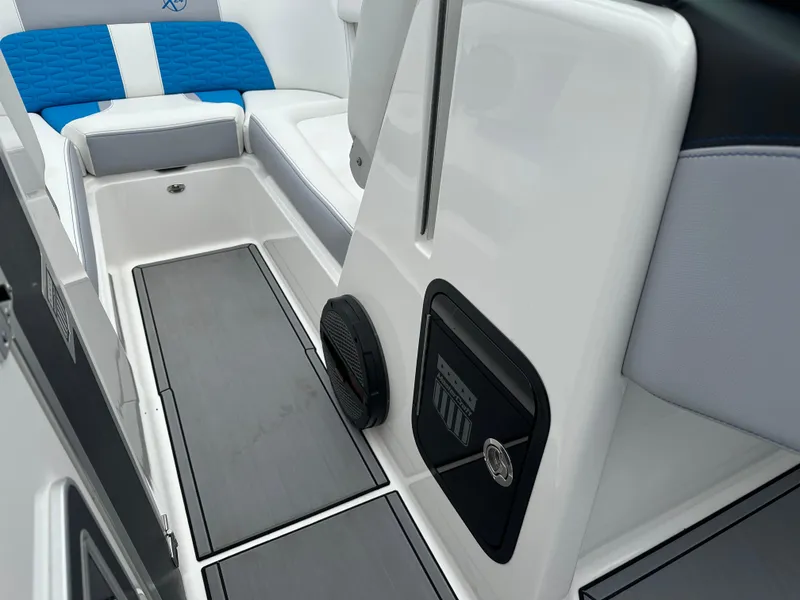 Slide: The Image of 2023 MasterCraft X24 interior with blue and white seating, sleek design, and modern features. - 19