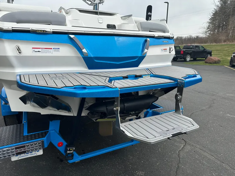 Slide: The Image of 2023 MasterCraft X24 boat rear view with swim platform and step ladder. - 6
