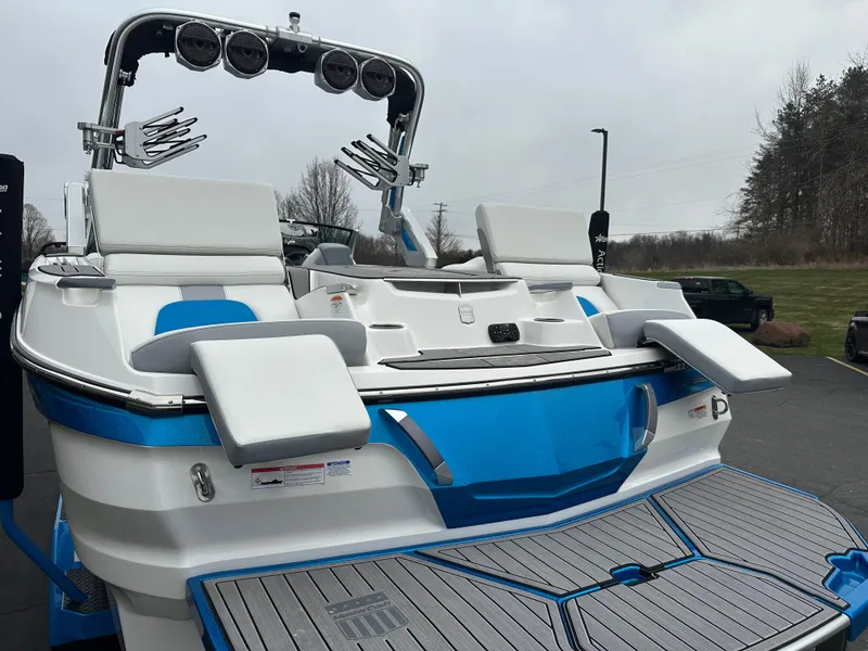 Slide: The Image of 2023 MasterCraft X24 boat with sleek design and modern features, docked outdoors. - 7