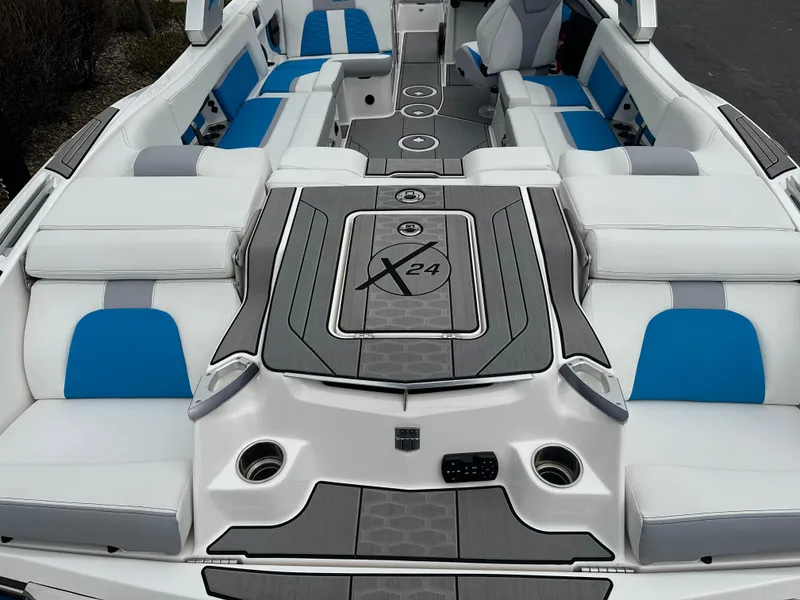 Slide: The Image of 2023 MasterCraft X24 boat interior with blue and white seating, sleek design. - 9