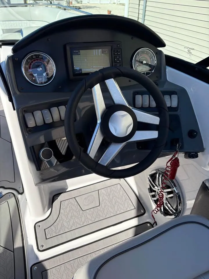 Slide: The Image of Steering console of 2022 Hurricane SunDeck 2486 OB boat with modern controls and gauges. - 5