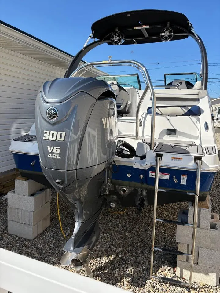 Slide: The Image of 2022 Hurricane SunDeck 2486 OB boat with Yamaha 300 V6 engine on a gravel surface. - 9