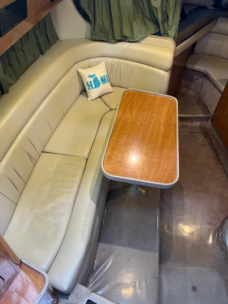 Slide: The Image of 2003 Regal Commodore 3260 interior with beige seating and wooden table. - 10