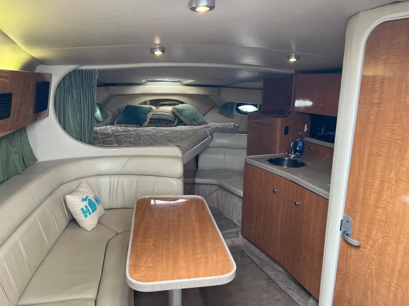 Slide: The Image of Interior of 2003 Regal Commodore 3260 yacht with seating, table, and kitchenette. - 11