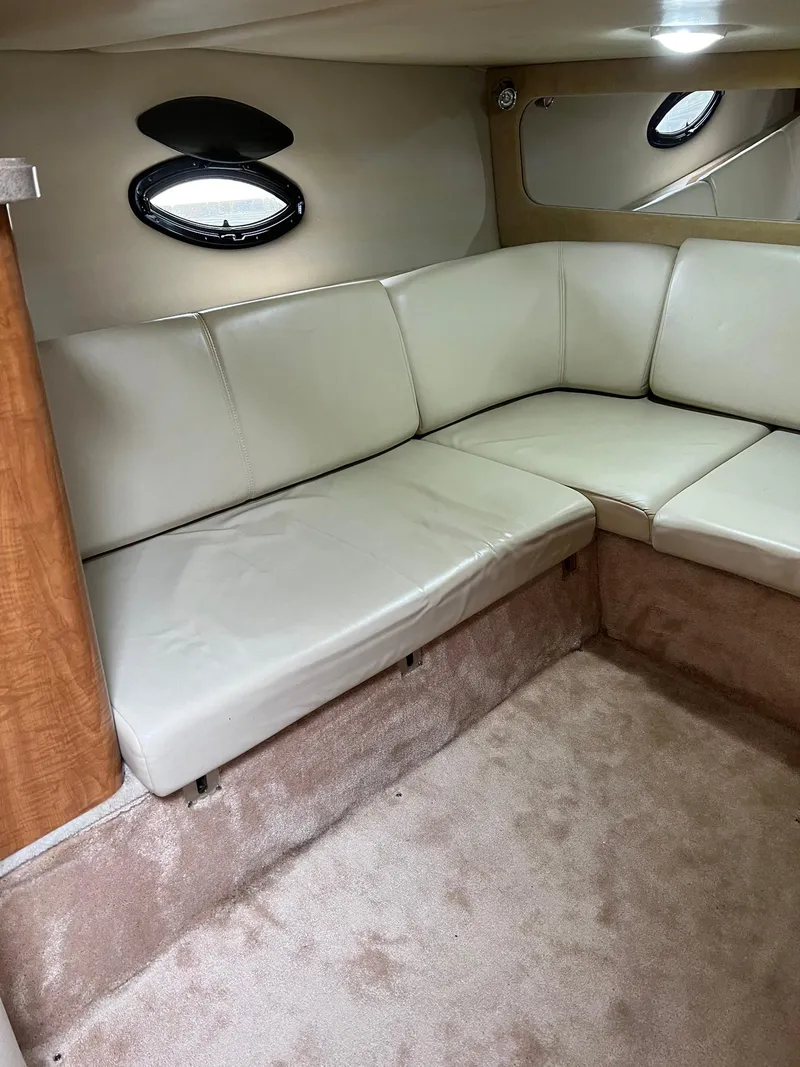 Slide: The Image of Interior of 2003 Regal Commodore 3260 yacht with beige leather seating and carpet. - 14