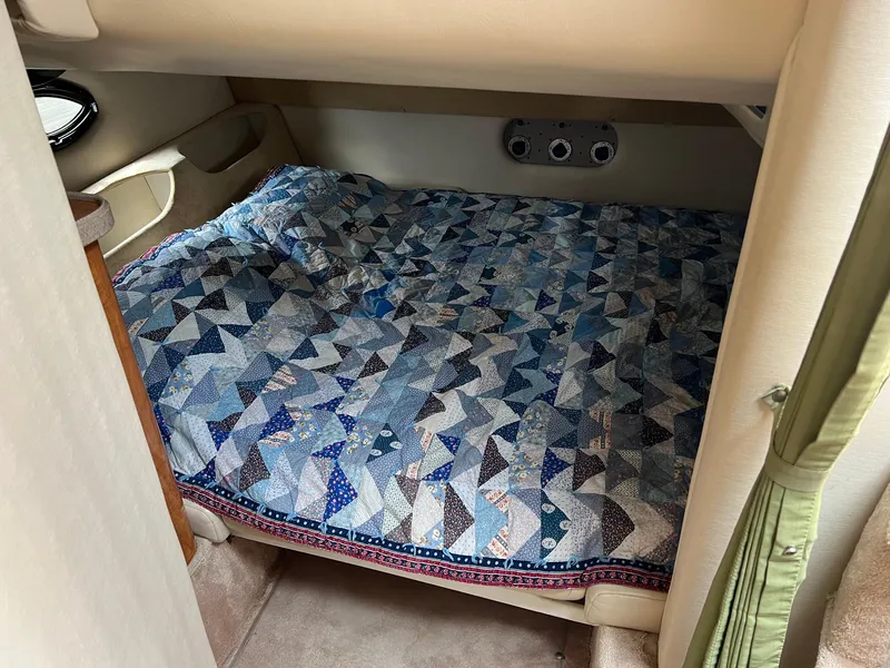 Slide: The Image of Cozy cabin bed in 2003 Regal Commodore 3260 with patterned quilt. - 16