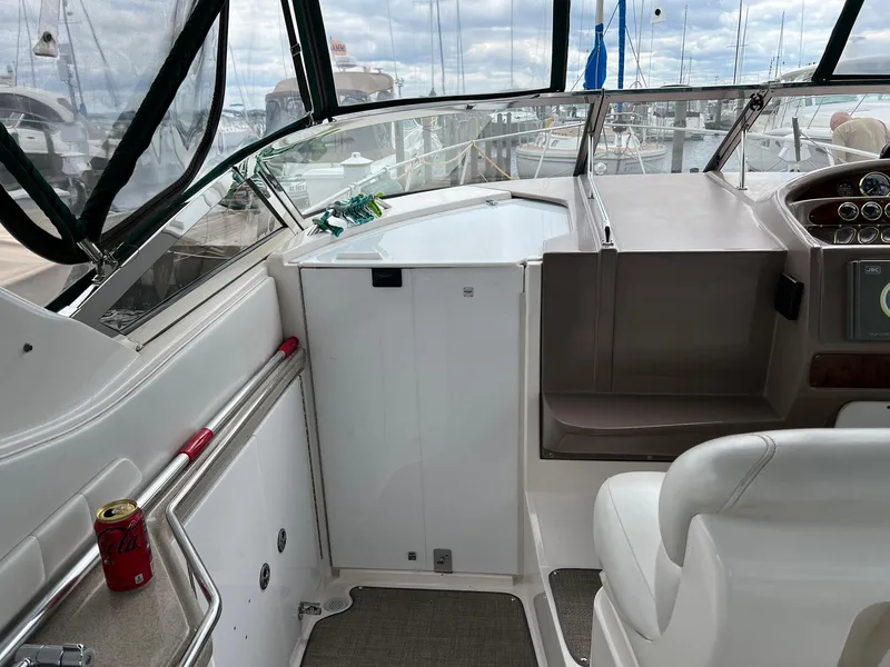 Slide: The Image of 2003 Regal Commodore 3260 boat interior with helm, seating, and marina view. - 4
