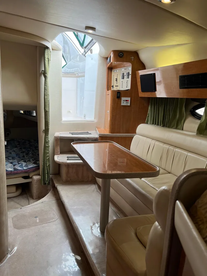 Slide: The Image of Interior of a 2003 Regal Commodore 3260 yacht with dining area and cozy seating. - 7