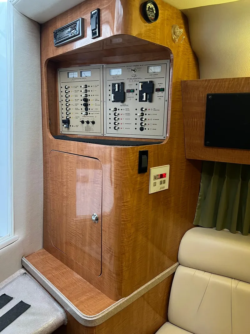 Slide: The Image of 2003 Regal Commodore 3260 control panel with wood finish and seating area. - 8