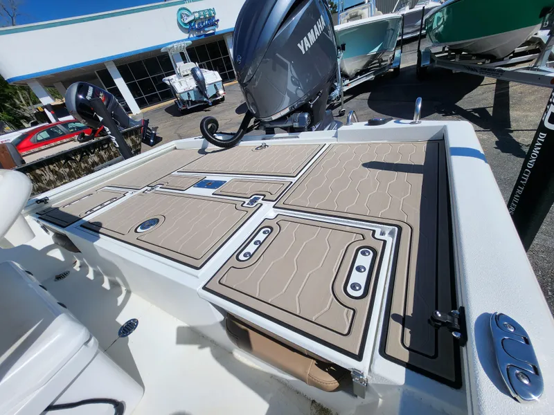 Slide: The Image of 2025 Avid 23FSX boat with Yamaha motor, displayed at a dealership. - 11