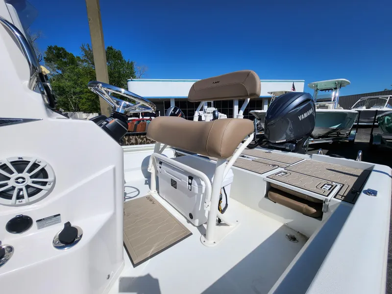 Slide: The Image of 2025 Avid 23FSX boat interior with Yamaha engine, featuring beige seating and control panel. - 12