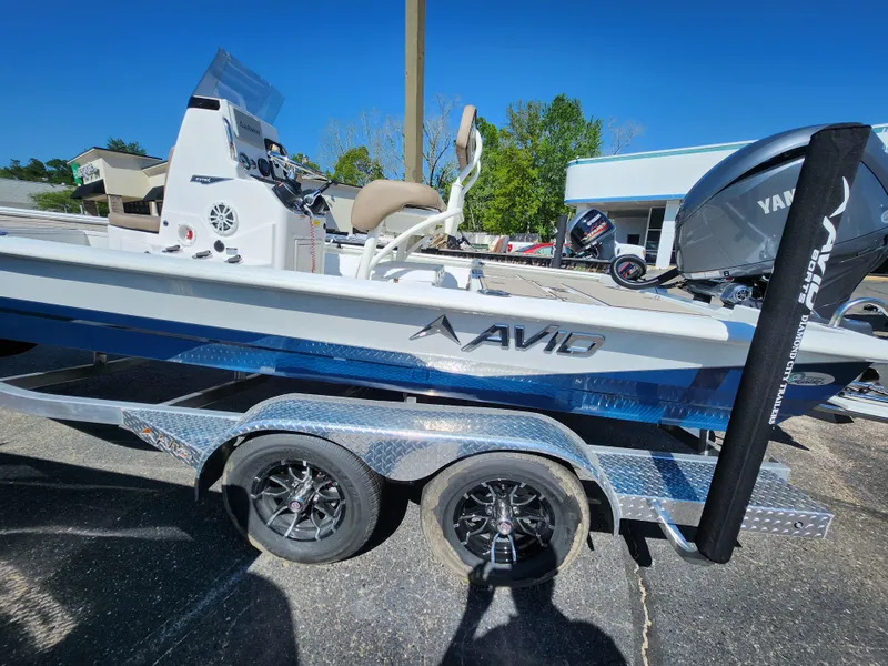 Slide: The Image of 2025 Avid 23FSX boat on trailer, featuring sleek design and modern equipment. - 14
