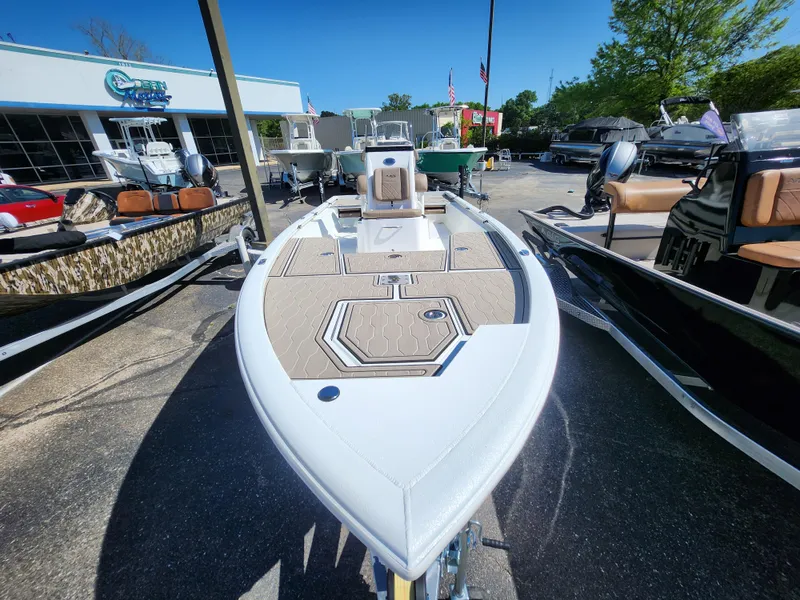 Slide: The Image of 2025 Avid 23FSX boat displayed outdoors at a dealership. - 3