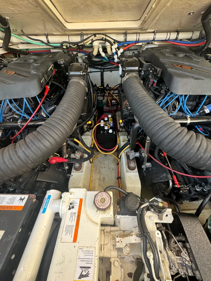 Slide: The Image of Engine compartment of a 2001 Pursuit 3000 Express boat, showcasing dual engines and wiring. - 10