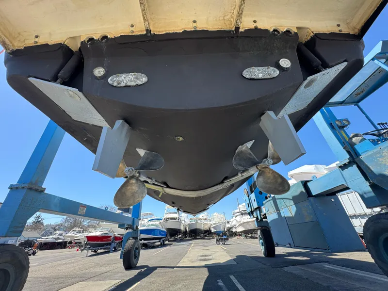 Slide: The Image of 2001 Pursuit 3000 Express boat hull and propellers in a marina setting. - 14