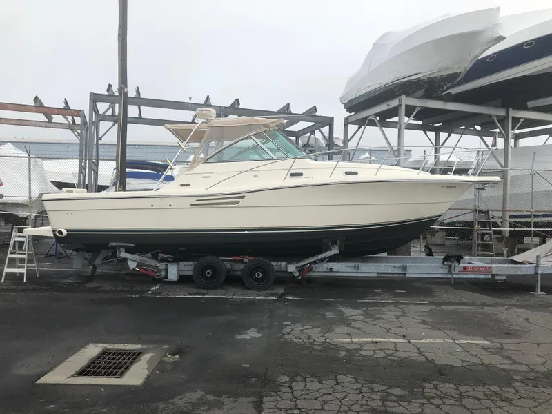 Slide: The Image of 2001 Pursuit 3000 Express boat on trailer in storage facility. - 38