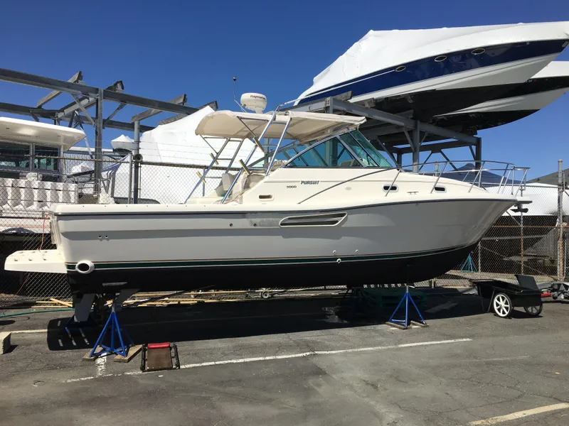 Slide: The Image of 2001 Pursuit 3000 Express boat on stands in a marina storage area. - 41